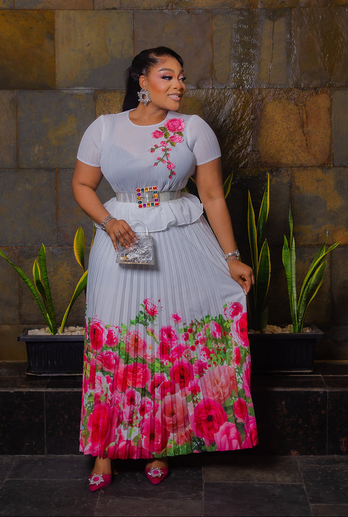 Blossom Beauty white Miyake pleated maxi skirt set featuring a floral peplum top, pearl buckle waist belt and flowing pink rose-print skirt.