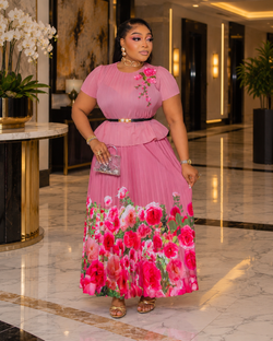 Blossom Beauty white Miyake pleated maxi skirt set featuring a floral peplum top, pearl buckle waist belt and flowing pink rose-print skirt.