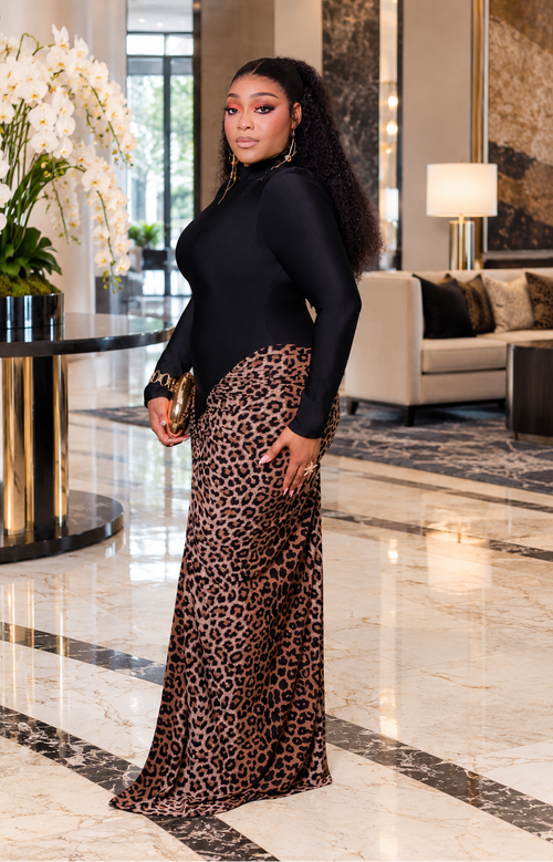 Side view of Naomi Panther Luxe maxi dress highlighting its fitted black bodice, leopard-print draping, and floor-length silhouette.